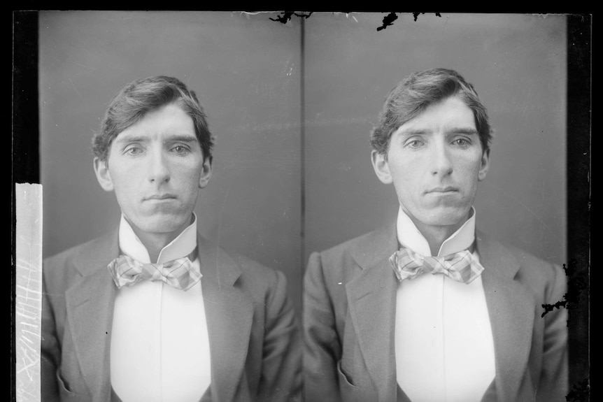 Black and white police photograph of a man in a suit and bow tie from the 1800s.