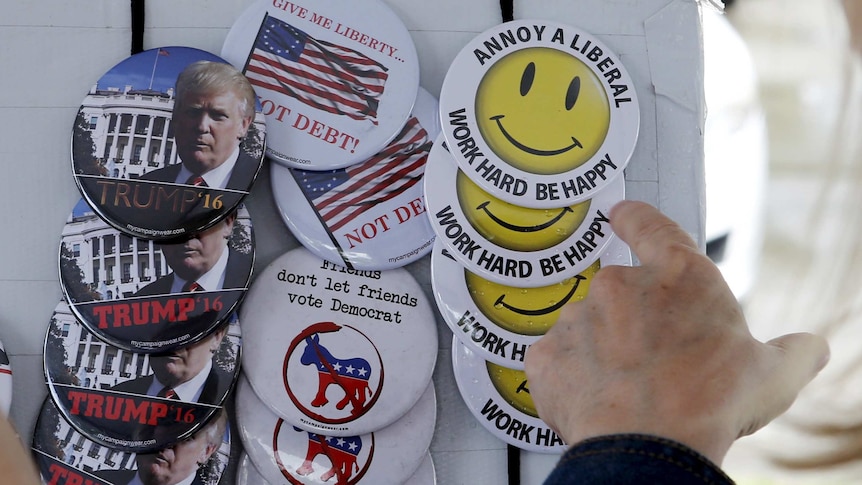 US Republican buttons reading "Trump '16", "Give me liberty not debt" and "Annoy a liberal; Work hard be happy".