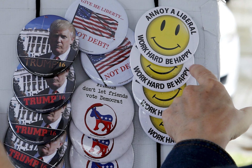 US Republican buttons reading "Trump '16", "Give me liberty not debt" and "Annoy a liberal; Work hard be happy".