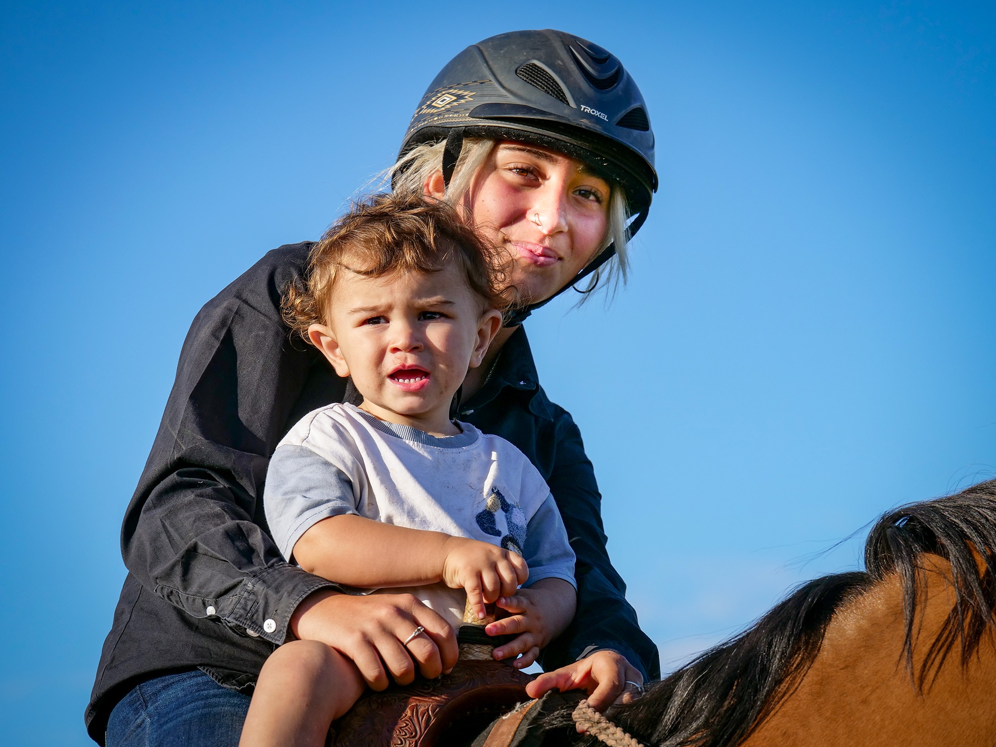 A woman and child on a horse.