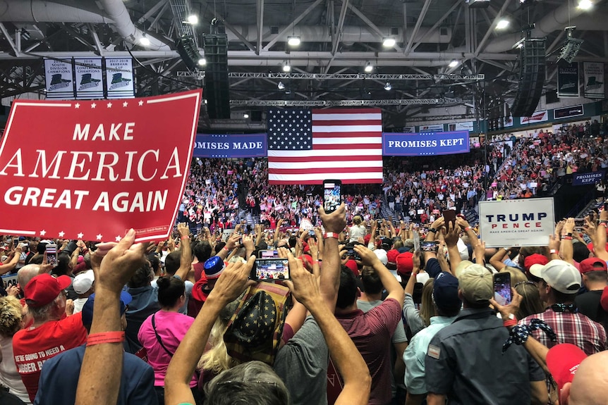 A crowd cheers at a rally for US president Donald Trump