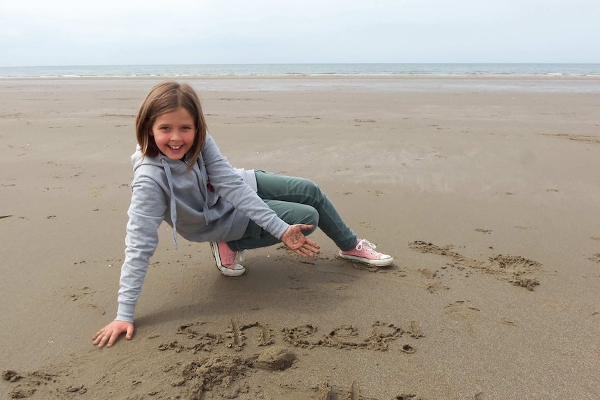 Heather Bowden-Page plays in the sand on the beach.