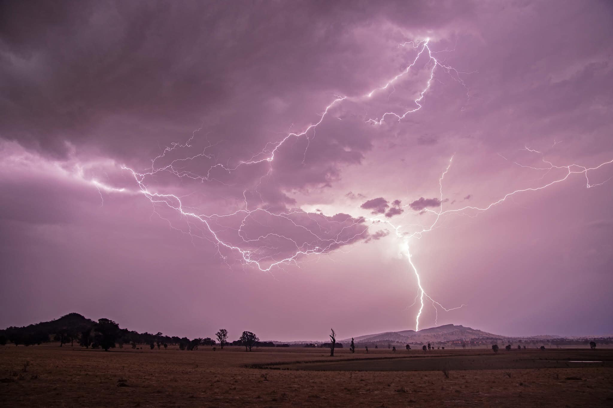 Lightning strikes from a red sky