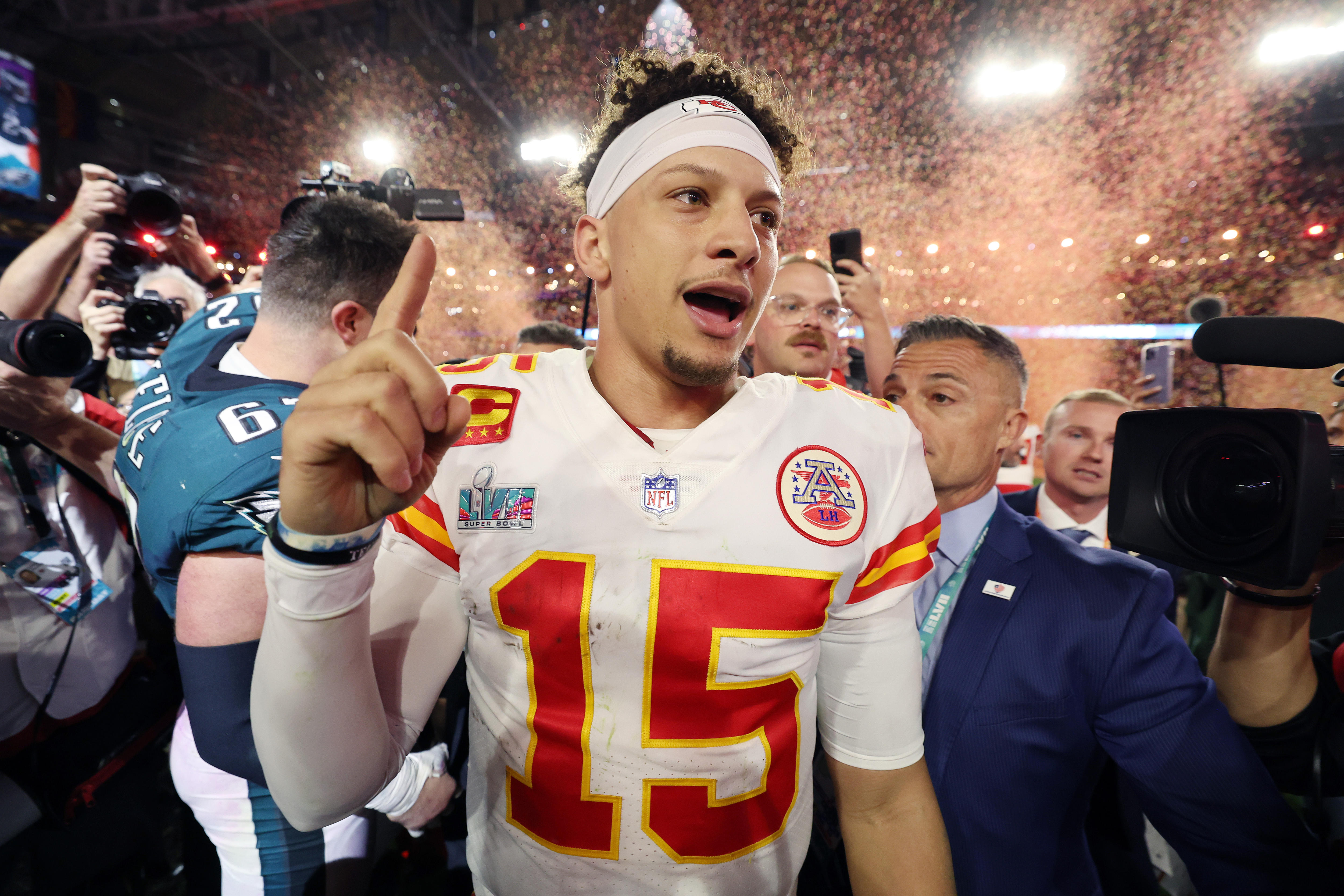Patrick Mahomes raises his right hand as he celebrates the Chiefs' winning the Super Bowl.