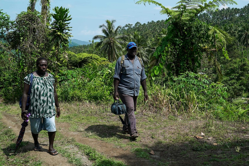 A woman and a man walk.