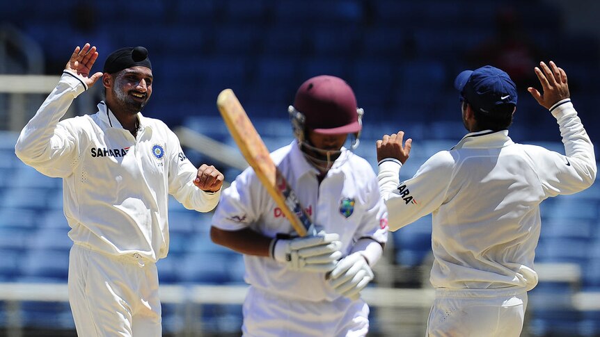 Harbhajan Singh (L) celebrates after taking the wicket of Carlton Baugh.