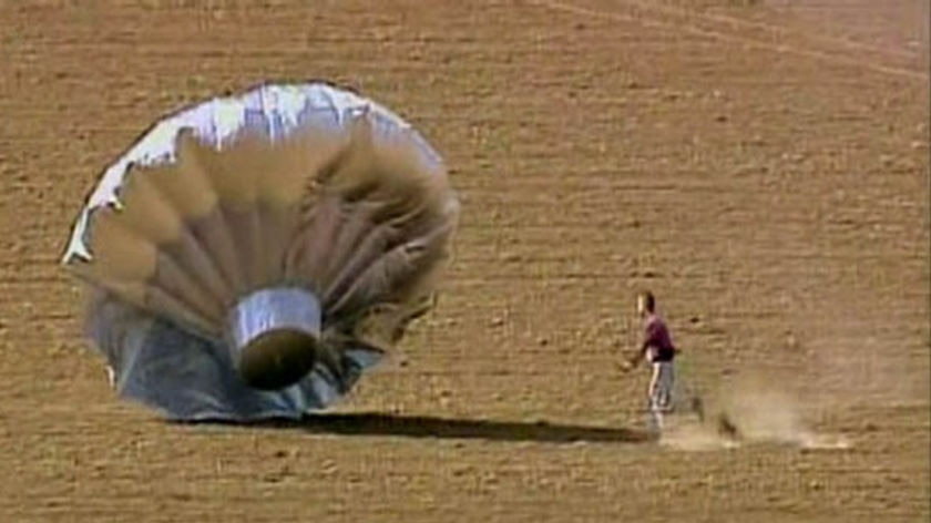 The balloon lands in a field