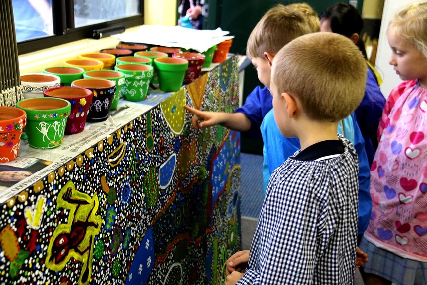 Children admiring their painting.