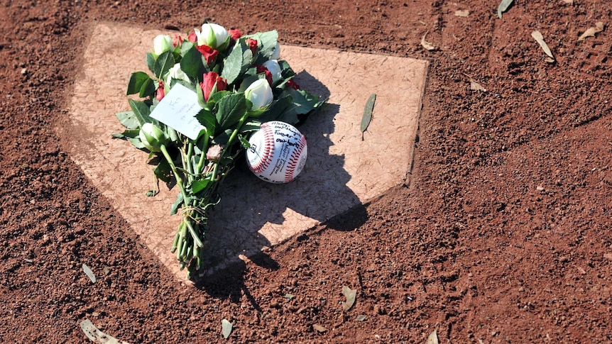 A tribute to Chris Lane is left on home plate at Essendon Baseball Club