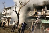 People look for survivors after a suicide bomb attack in Adhamiya