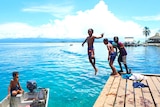 Children jumping off the jetty at Gizo, in the pristine Western Province of Solomon Islands.