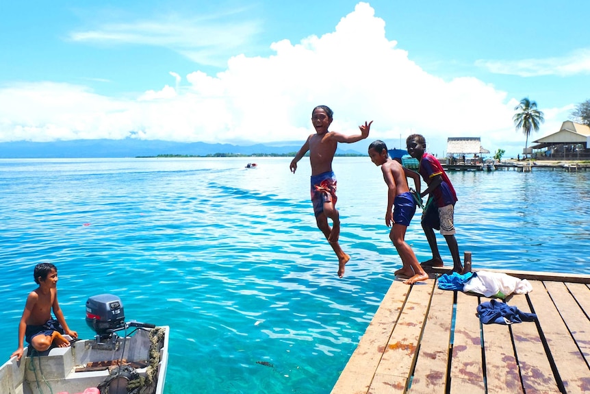 Children jumping off the jetty at Gizo, in the pristine Western Province of Solomon Islands.