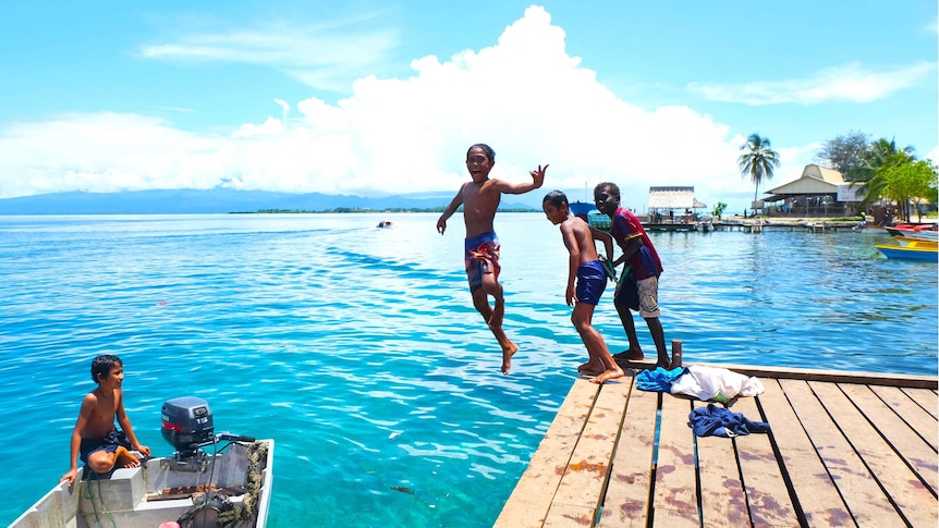 Children jumping off the jetty at Gizo, in the pristine Western Province of Solomon Islands.