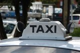Taxi sign on the roof of a cab