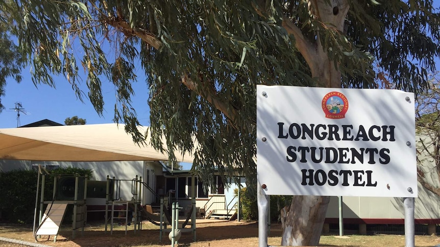 The Longreach Students Hostel sign in front of a collection of buildings.