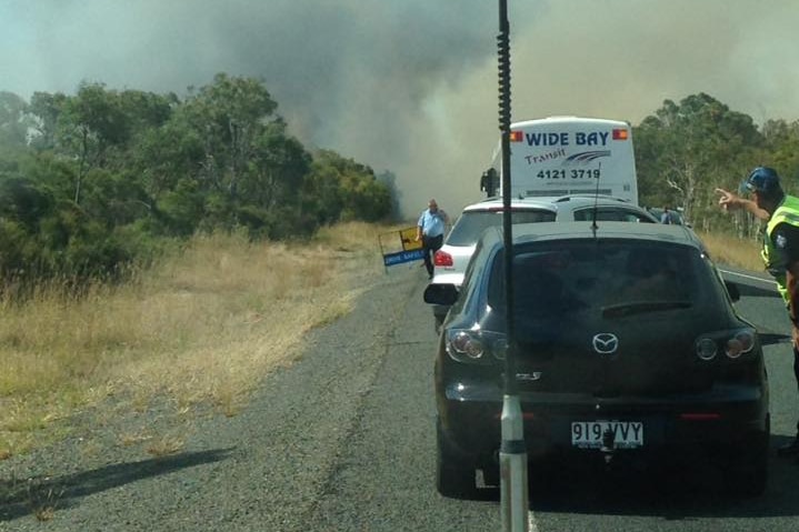 Cars stopped by emergency services on a road on Queensland's Fraser Coast.