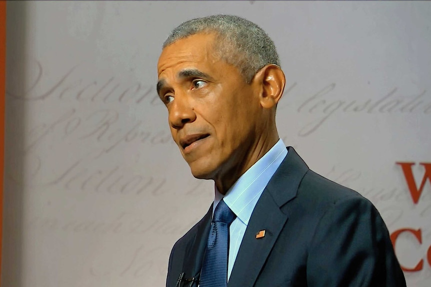 Barack Obama speaking in a suit