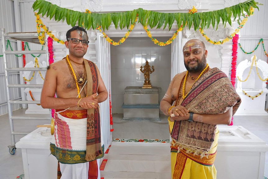 Two priest standing in North Queensland's first Hindu temple at Gumlow in Townsville.