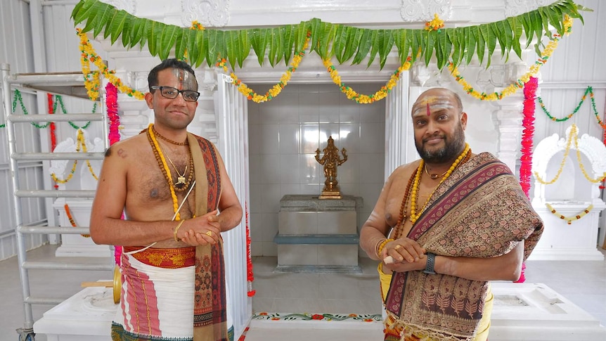 Two priest standing in North Queensland's first Hindu temple at Gumlow in Townsville.
