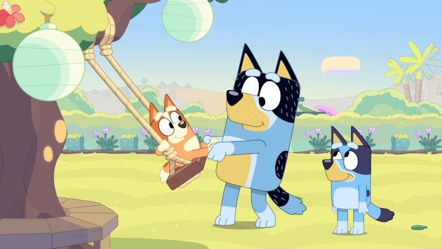 Still from Bluey episode The Sign showing three cartoon dogs in a backyard playing on a swing.