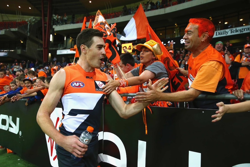 The Giants' Jeremy Cameron celebrates with fans after his team's win over Hawthorn.
