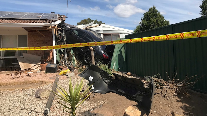 A car sits wedged into a house in Isabella Plains, Canberra.