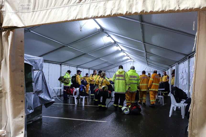 Rural Fire Service and SES volunteers in a tent