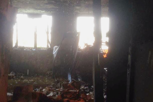 another image shows a gutted entrance to an apartment inside the grenfell tower