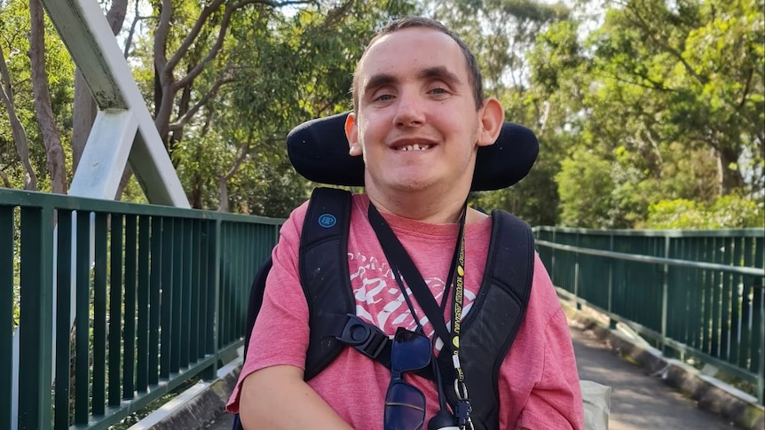 a man in a wheelchair on a bridge