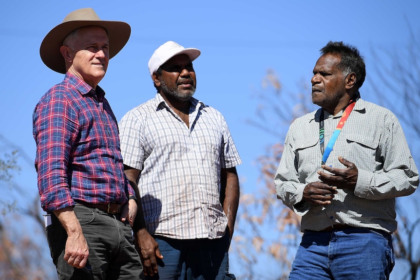 Prime Minister Malcolm Turnbull stands with traditional owner Ronald Plummer