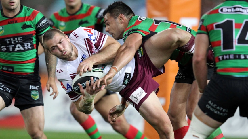 Manly's Kieran Foran is tackled by the Rabbitohs defence during the 2013 preliminary final.