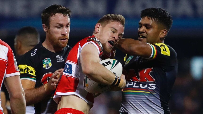 Matthew Dufty is tackled by James Maloney and Tyrone Peachey.