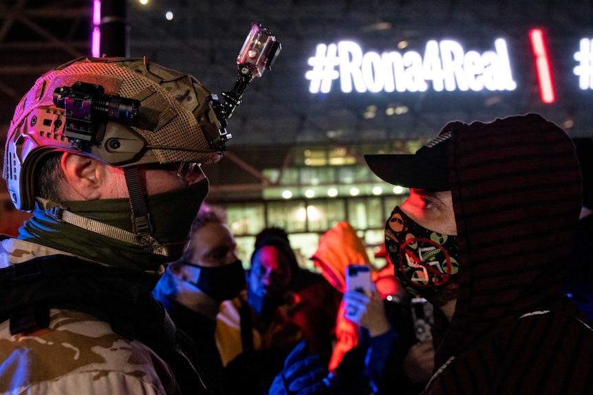 A supporter of US President Donald Trump (left) argues with a counter-protester.