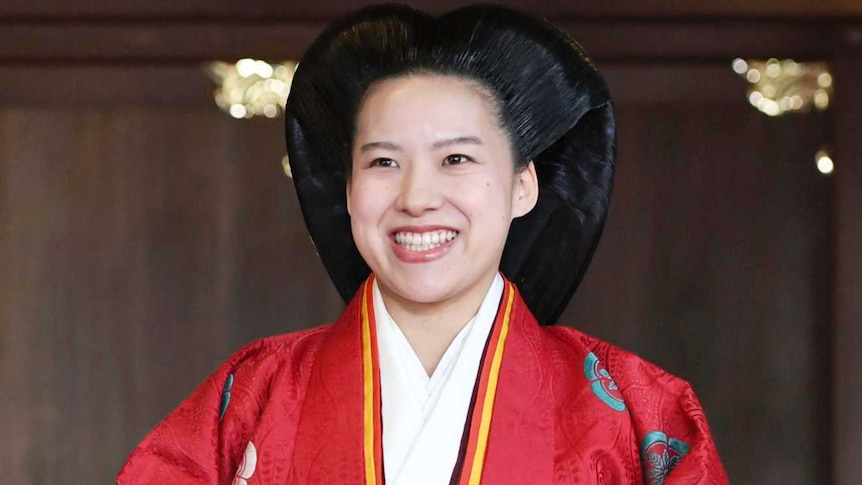 Japanese Princess Ayako, right, dressed in traditional ceremonial robe, and groom Kei Moriya, left.