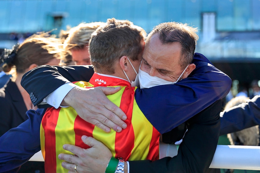 Trainer Chris Waller hugs jockey James McDonald after The Everest