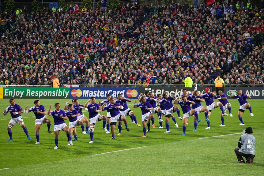 Rugby players perform the Siva Tau before a game.