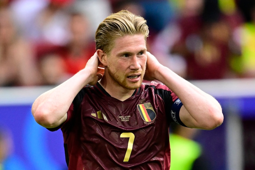 Kevin De Bruyne holds his head after Belgium's loss