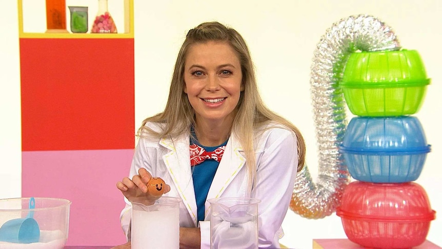 Rachael on the Play School Science Time set wearing a lab coat with a sea turtle made out of an egg