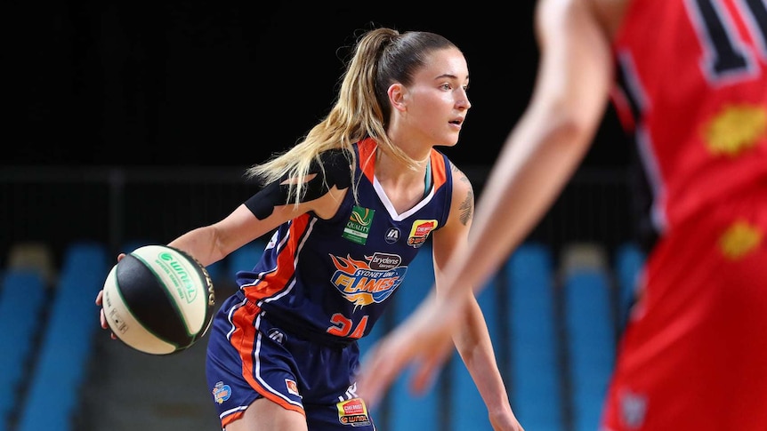 Anneli Maley dribbles a basketball during a WNBL game.