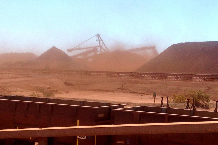 dusty piles of dirt in a port.