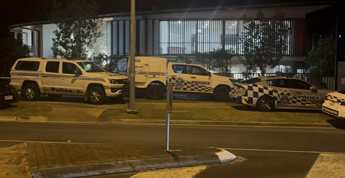 Police cars outside a childcare centre at night.