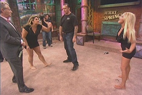 Two barefoot women fight on The Jerry Springer Show.