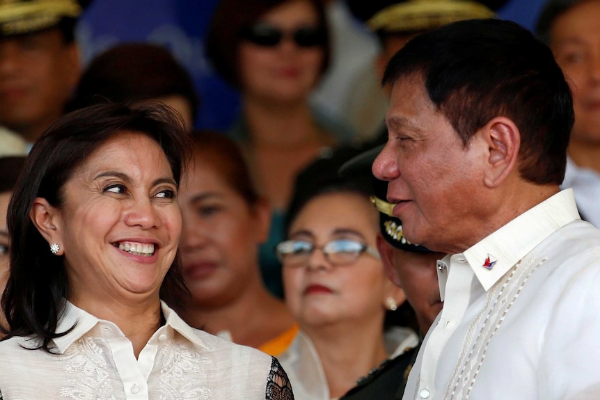 Leni Robredo smiles at Philippines President Rodrigo Duterte