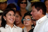 Leni Robredo smiles at Philippines President Rodrigo Duterte