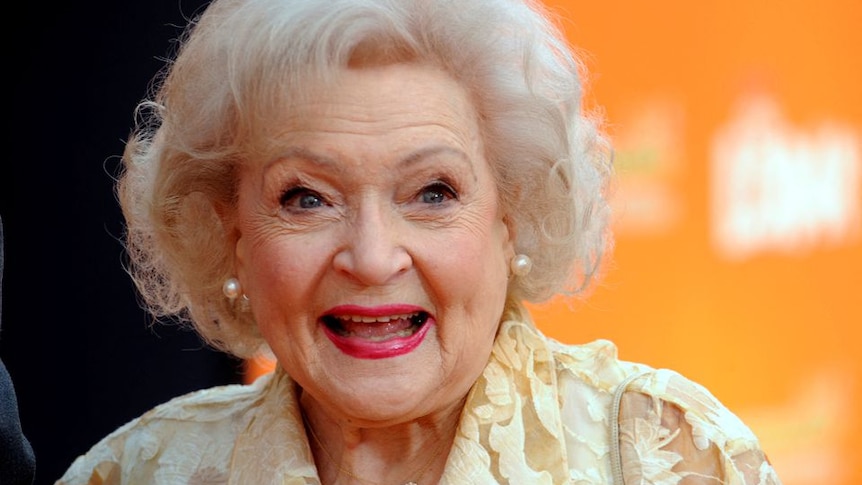 A photo of Betty White, with short curly white hair smiling 