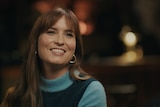A headshot of Missy Higgins smiling in a green skivvy