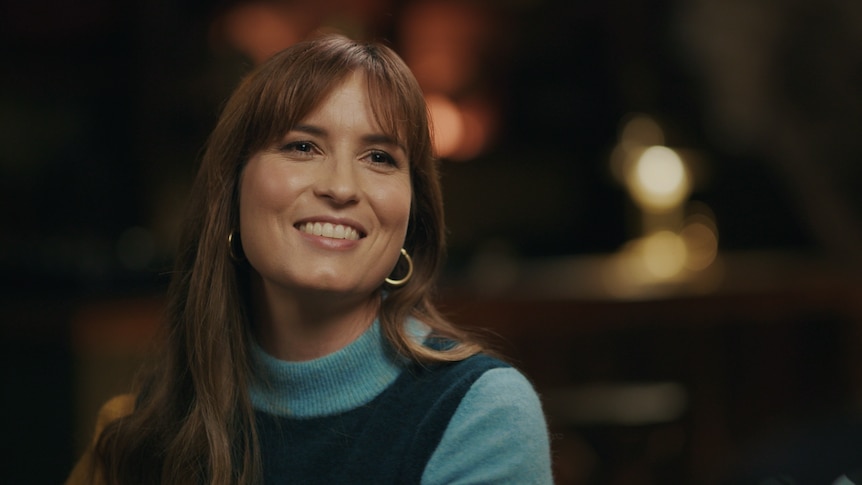 A headshot of Missy Higgins smiling in a green skivvy