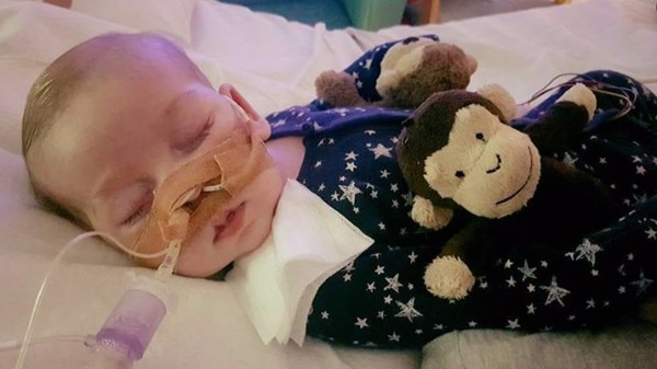 Baby Charlie Gard wears starred pyjamas and holds a monkey plush toy as he sleeps in the hospital attached to life support.