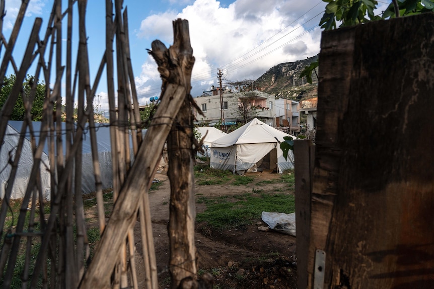 A group of tents erected in a village near Antakya surrounded by a fence of sticks.