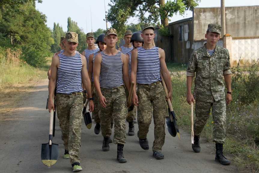 Trainee soldiers walk down the road near Odessa, Ukraine.